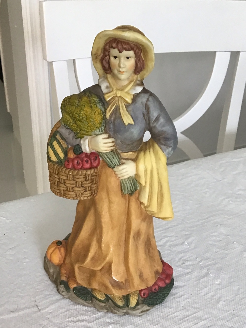 The Harvest Maiden Figurine carrying a basket with fruit. #41#4